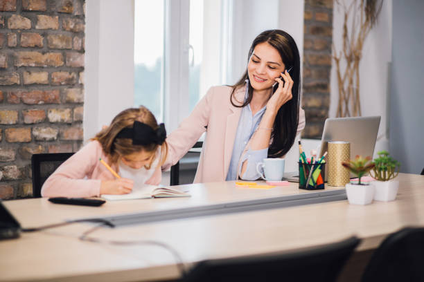istock Happy woman bringing child to work 1166366788