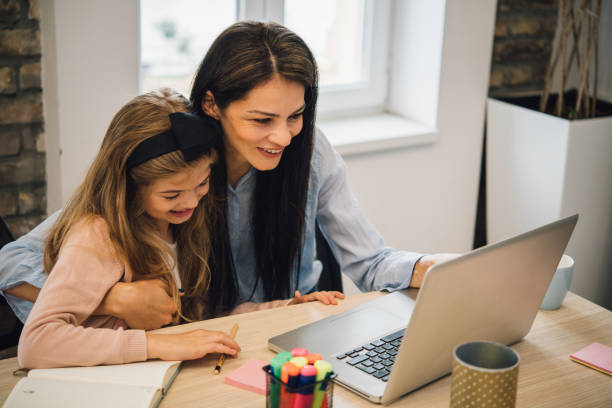 istock Mother and daughter using laptop 1166366793