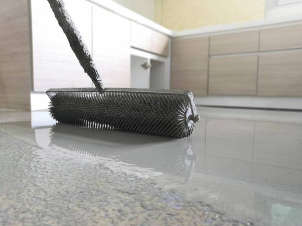 istock Self-leveling concrete is typically used to create a flat and smooth surface with a compressive strength similar to or higher than that of traditional concrete prior to installing interior floor. 1166367813