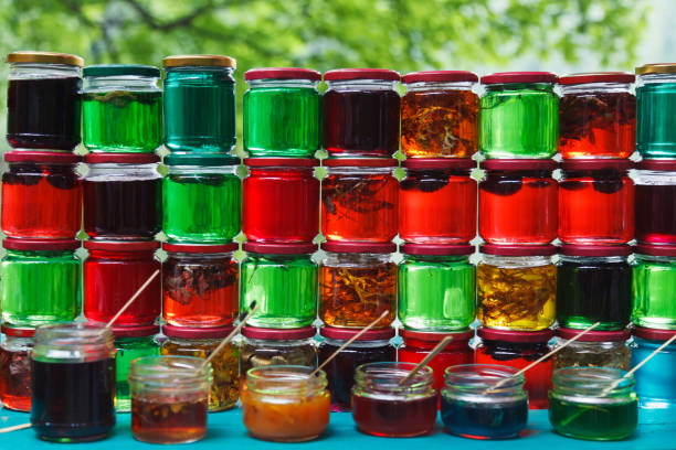 istock Green, red and yellow jars with honey. 1166369300