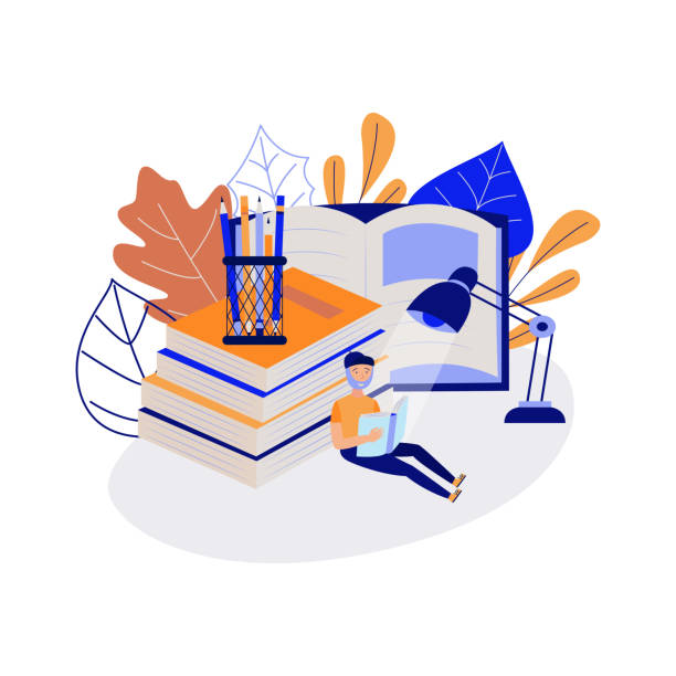 istock Young student sitting on floor and reading book surrounded by large school supplies. 1166369803