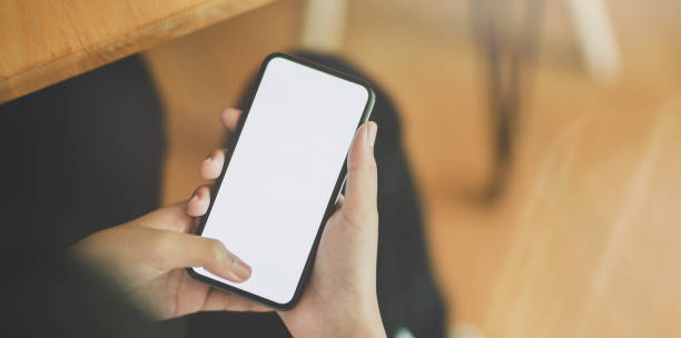 istock Young girl holding blank screen smartphone 1166371376