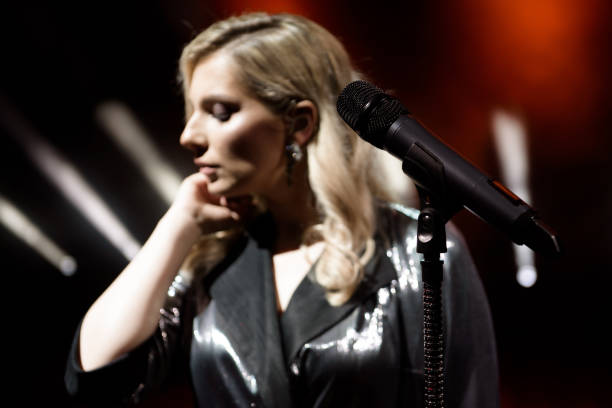 istock Singer woman on stage. Singer and microphone. 1166372346