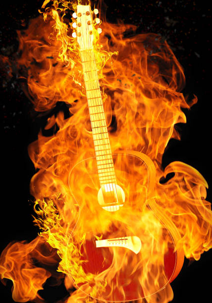 istock Burning guitar on black background isolated 1166372391