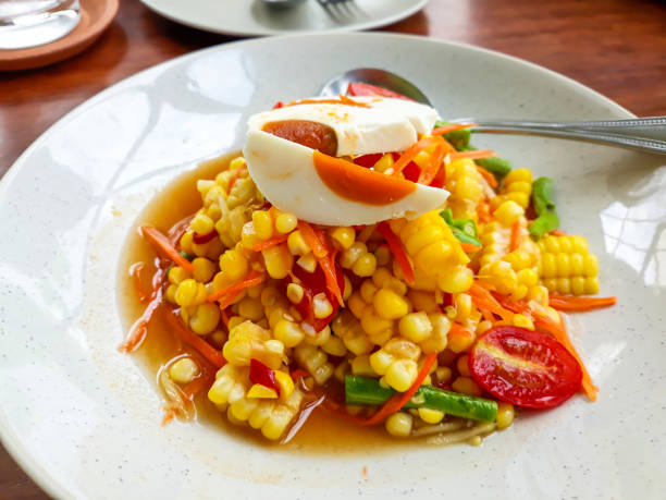 istock Spicy salad with corn  and salted eggs ,Thai food. 1166372931