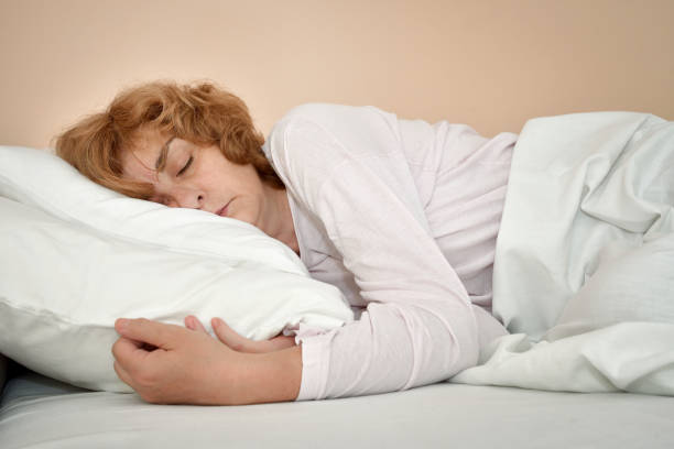 istock Woman sleeping in bed 1166375115