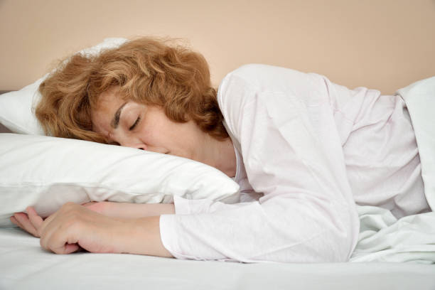 istock Woman sleeping in bed 1166375116