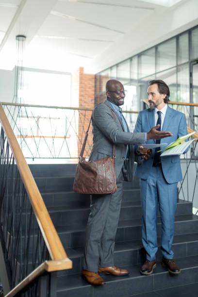 istock Two businessmen discussing the meeting while reading reports 1166375308