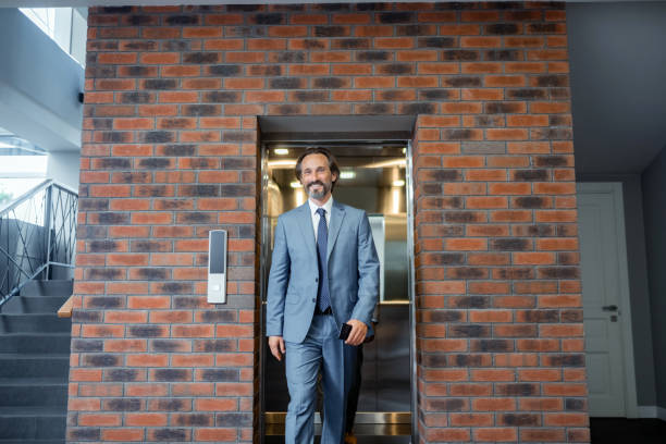 istock Grey-haired businessman wearing suit and tie feeling motivated 1166375944
