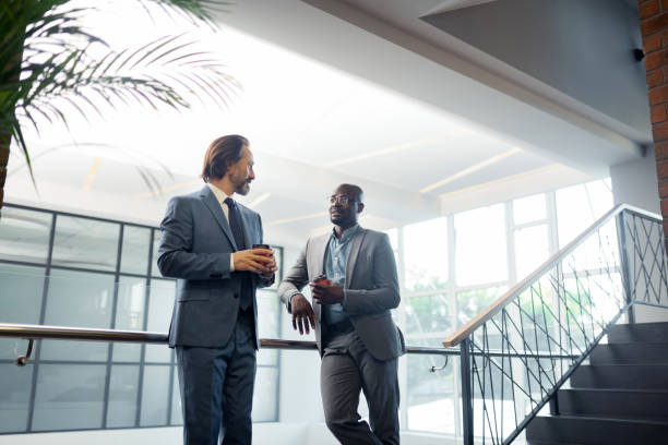 istock Bearded businessman speaking with partner and having coffee time 1166375947
