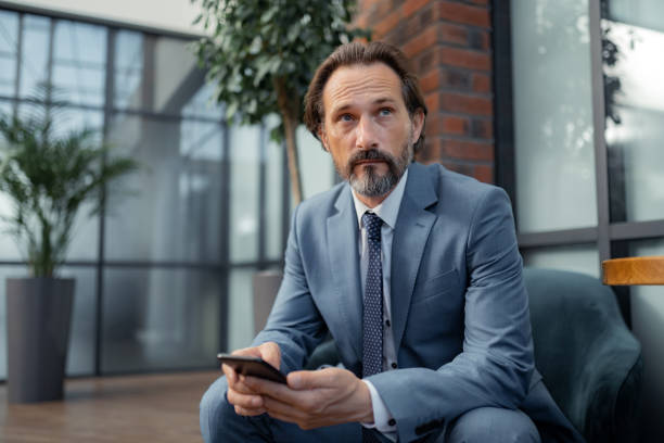 istock Businessman feeling thoughtful while waiting for the meeting 1166375979