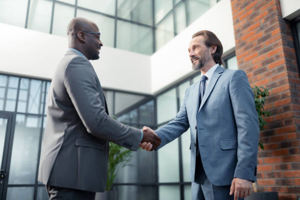 istock Man smiling while meeting his African-American investor 1166375982