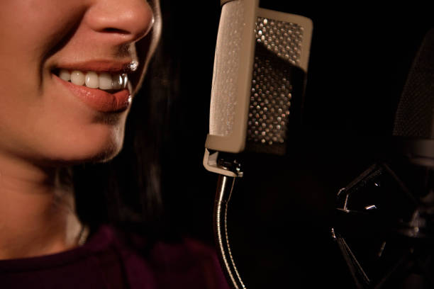istock Young woman singer in front of microphone. 1166376209