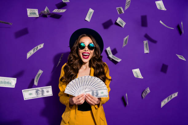 Portrait of her she nice lovely cheerful cheery luxury excited rich wealthy wavy-haired lady winner currency flying budget salary isolated over bright vivid shine violet lilac background Portrait of her she nice lovely cheerful cheery luxury excited rich wealthy wavy-haired, lady winner currency flying budget salary isolated over bright vivid shine violet lilac background jackpot photos stock pictures, royalty-free photos & images