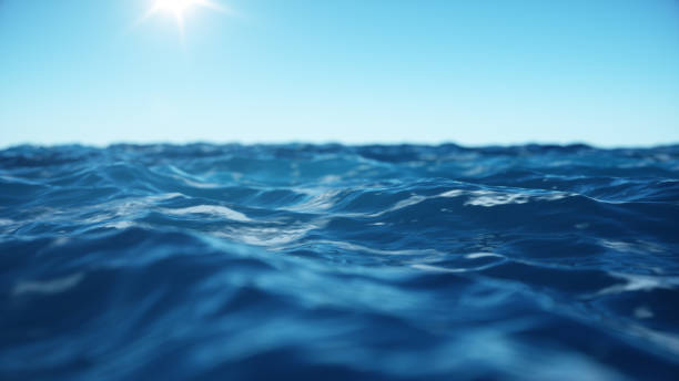 istock Sea wave low angle view. Ocean water background. View from below, view of a clear blue sky with the sun. Sea or ocean wave close-up view. Beautiful blue clean water. 3D rendering 1166376628