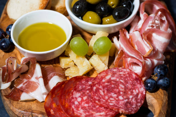 istock cold cuts, bread and cheese on wooden board, closeup 1166376702
