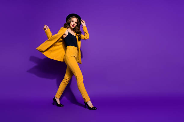 istock Profile side full length body size view of nice-looking gorgeous attractive content cheerful cheery wavy-haired lady motion touching hat isolated over bright vivid shine violet lilac background 1166376810