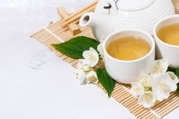 istock japanese tea ceremony. green tea with jasmine. white background 1166376812