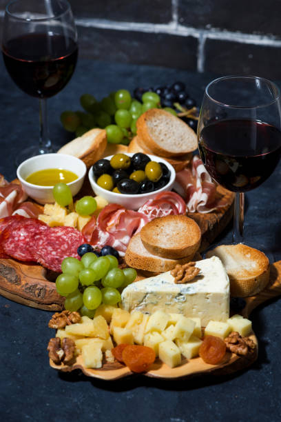 istock cheese platter, bread, fruit and cold cuts to wine, vertical closeup 1166377100