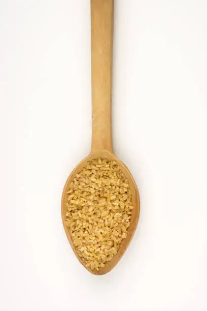 Bulgur in wooden scoop