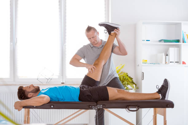 istock Physiotherapist assisting a young patient in recovery 1166378834