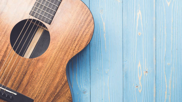 istock New brown guitar on wooden board 1166379020