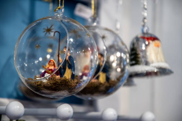 Transparent glass bulbs with nativity scene diorama inside. Beautiful Christmas tree ornaments closeup. Holiday decor. Christmas decorations. Christmas fair in Berlin Germany. New Year celebration stock photo