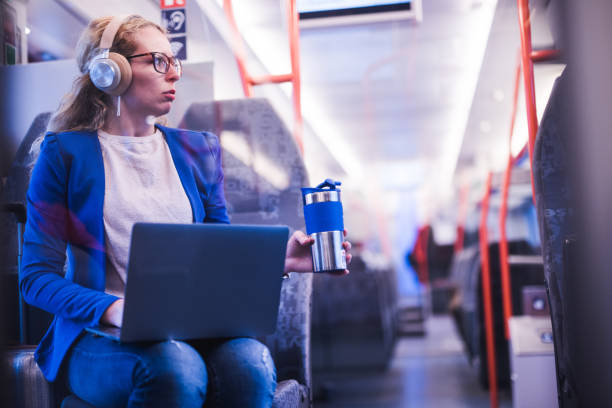 istock Young businesswoman drinking coffee in train. 1166379872
