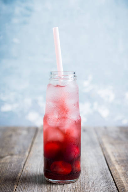 istock Cherry drink with berries and ice in small bottle 1166380168