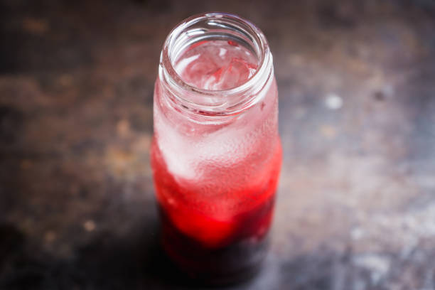 istock Cherry drink with berries and ice in small bottle 1166380178