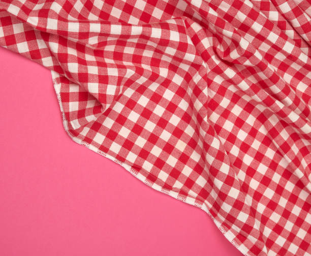 istock white red checkered kitchen towel on a pink background 1166381828