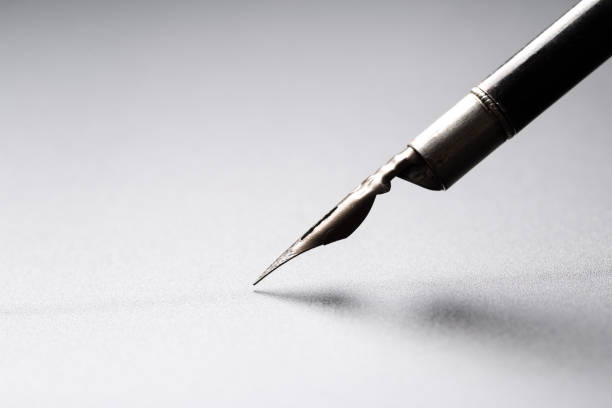 istock Old fountain pen on a black textured background 1166382299