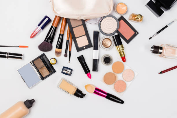 istock Makeup products with cosmetic bag and macaroons on light background 1166383325