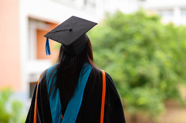 istock Portraits on the back of the graduates wearing a black ruffle dress at the university. 1166383473