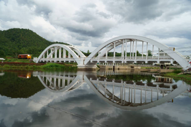 istock Diesel locomotive passing the Tha Chom Phu railway bridge or white bridge 1166383676