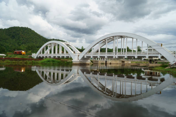 istock Diesel locomotive passing the Tha Chom Phu railway bridge or white bridge 1166383797