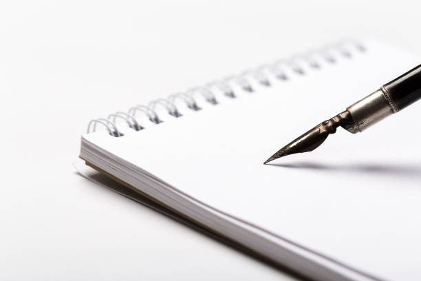 istock diary with fountain pen on white close-up 1166385317