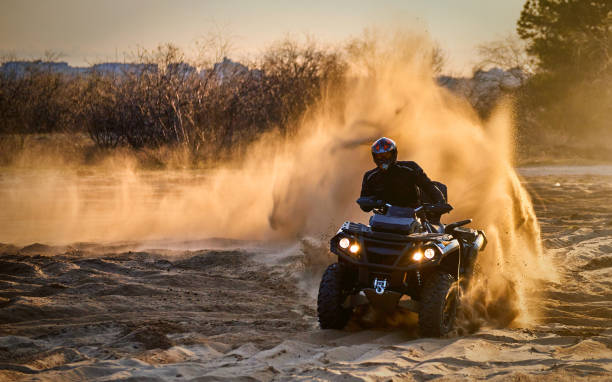 istock Racing powerful quad bike on the difficult sand in the summer. 1166385389