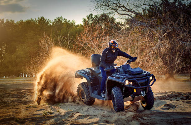 istock Racing powerful quad bike on the difficult sand in the summer. 1166385394