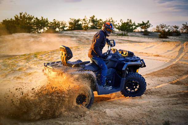 istock Racing powerful quad bike on the difficult sand in the summer. 1166385401
