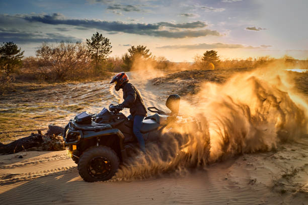 istock Racing powerful quad bike on the difficult sand in the summer. 1166385404