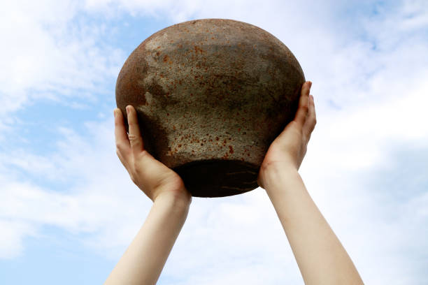 istock old cast iron stove pot raised above his head, found an artifact 1166386039