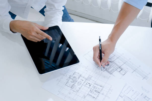 istock Colleagues interior designer Corporate Achievement Planning Design on blueprint Teamwork Concept with compasse. 1166389373