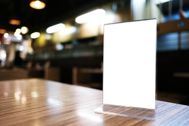 istock Mock up Menu frame standing on wood table in Bar restaurant cafe. space for text 1166389379