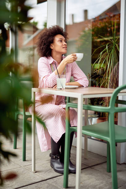 istock Woman drinking coffee in cafe. 1166389990