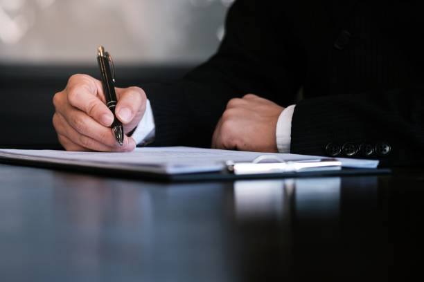 istock Businessman analyzing investment charts and pressing calculator buttons over documents. Accounting Concept. 1166390830