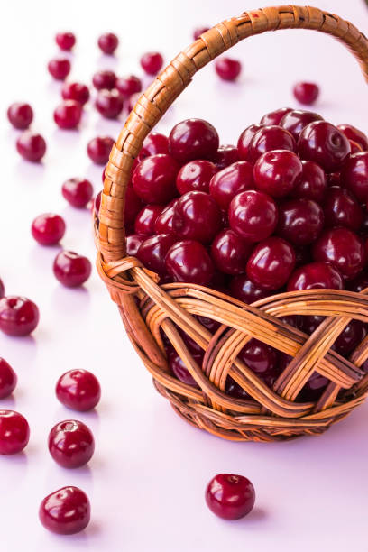 istock Cherry berries in a wicker basket. White background, part of the frame 1166390879