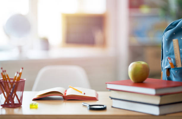 istock Apple, pile of books and backpack 1166392386