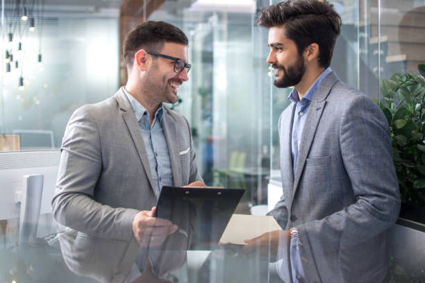istock Two handsome business men discussing contract in office 1166392439