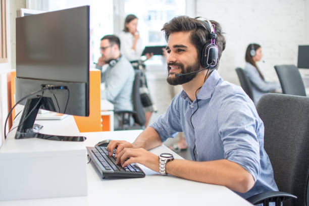 istock Young handsome man wearing headset working on computer in call center 1166392734